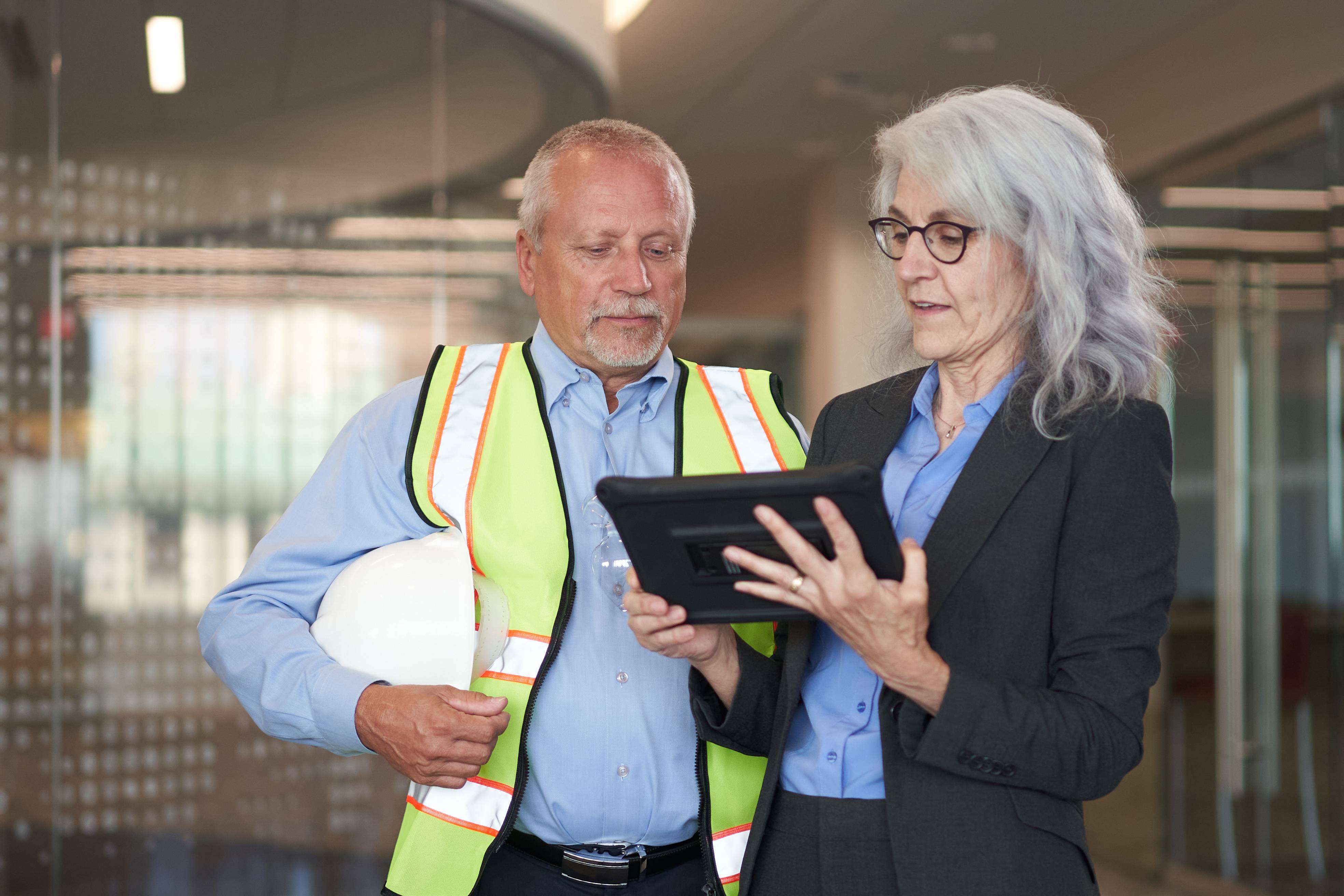 man and woman looking at a tablet